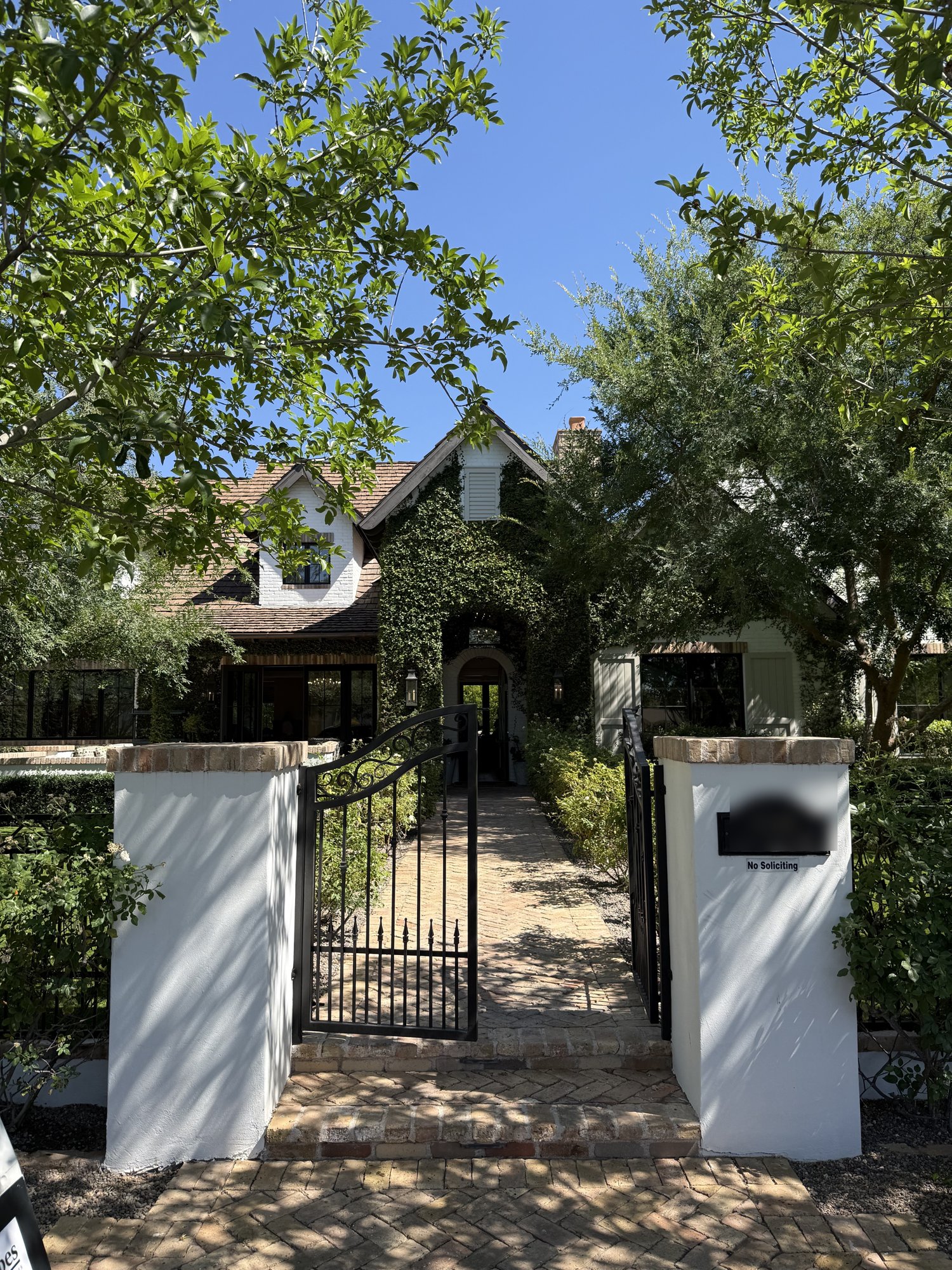Ivy-covered Arcadia home behind a gated entrance
